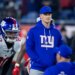 New York Giants interim defensive coordinator Charlie Bullen in a blue hoodie and cap on the field.