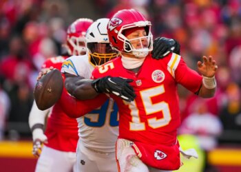 Los Angeles Chargers linebacker Odafe Oweh (98) sacks Kansas City Chiefs quarterback Patrick Mahomes (15) during the second half at GEHA Field at Arrowhead Stadium.