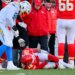 Kansas City Chiefs quarterback Patrick Mahomes (15) on the ground as Chargers defensive tackle Justin Eboigbe (92) and Chiefs head coach Andy Reid watch.