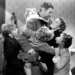 James Stewart embracing Donna Reed and four children.