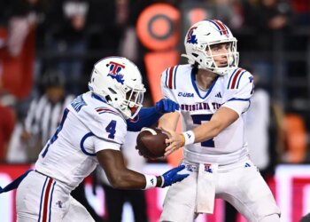 Louisiana Tech Bulldogs running back Clay Thevenin (4) takes the hand off from quarterback Evan Bullock (7).