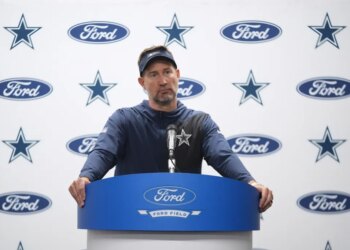 Dallas Cowboys coach Brian Schottenheimer speaking at a press conference.