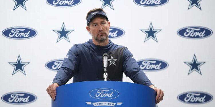 Dallas Cowboys coach Brian Schottenheimer speaking at a press conference.