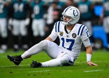 Colts quarterback Daniel Jones grabs his right ankle after suffering an injury against the Jaguars on Dec. 7, 2025.