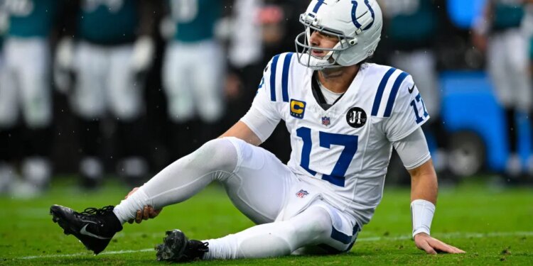 Colts quarterback Daniel Jones grabs his right ankle after suffering an injury against the Jaguars on Dec. 7, 2025.