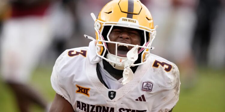 Arizona State running back Raleek Brown shouts with his mouth open while wearing his football helmet and white uniform with "3" on the shoulder.