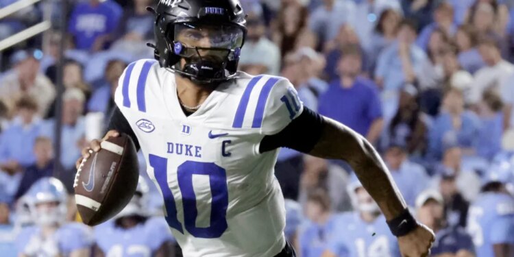 Duke quarterback Darian Mensah (10) rolls out during a college football game against North Carolina.