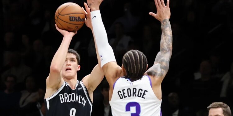 Egor Dëmin shoots a 3-pointer over Keyonte George during the Nets' 123-110 home loss to the Jazz on Dec. 4, 2025.