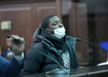 Frederick Green, wearing a white face mask, black puffer coat, and black hoodie, is arraigned in Manhattan Criminal Court.