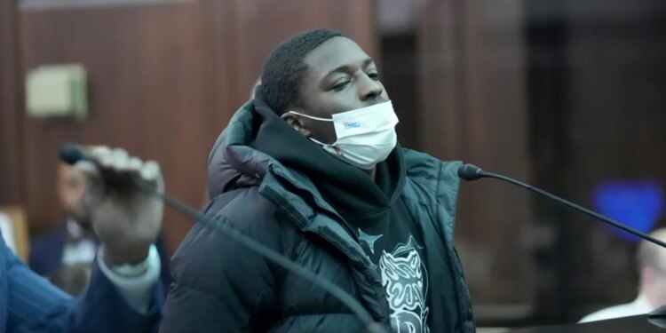 Frederick Green, wearing a white face mask, black puffer coat, and black hoodie, is arraigned in Manhattan Criminal Court.