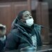 Frederick Green, wearing a white face mask, black puffer coat, and black hoodie, is arraigned in Manhattan Criminal Court.