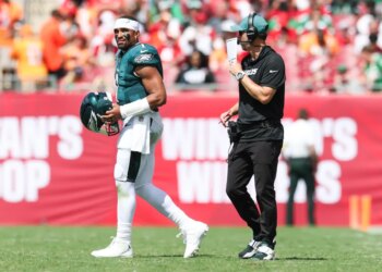 Philadelphia Eagles offensive coach Kevin Patullo communicates with quarterback Jalen Hurts during a timeout.