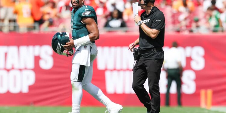 Philadelphia Eagles offensive coach Kevin Patullo communicates with quarterback Jalen Hurts during a timeout.