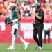 Philadelphia Eagles offensive coach Kevin Patullo communicates with quarterback Jalen Hurts during a timeout.