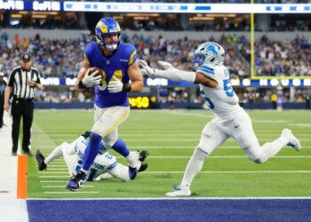 Los Angeles Rams tight end Colby Parkinson (84) scores a touchdown past Detroit Lions linebacker Derrick Barnes (55).