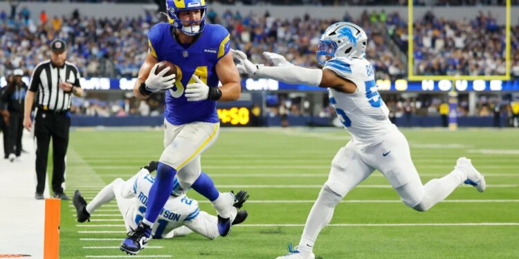 Los Angeles Rams tight end Colby Parkinson (84) scores a touchdown past Detroit Lions linebacker Derrick Barnes (55).