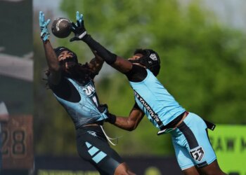 Raw Miami wide receiver Calvin Russell, left, catches a touchdown pass in front of RG3 Takover's Chris Stewart, right, during OT7 football Week 3, Saturday, March 29, 2025, in Dallas.
