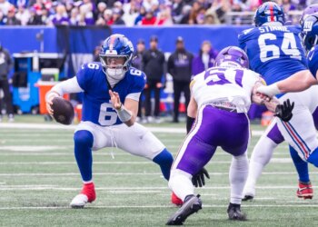 Quarterback Jaxson Dart #6 of the New York Giants is forced out of the pocket by linebacker Blake Cashman #51 of the Minnesota Vikings during the first half at MetLife Stadium, Sunday, Dec. 21, 2025, in East Rutherford, New Jersey.