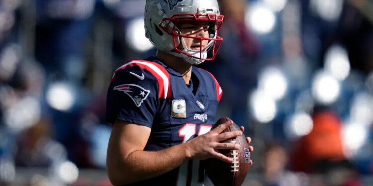 Falcons Patriots Football player holding a football.