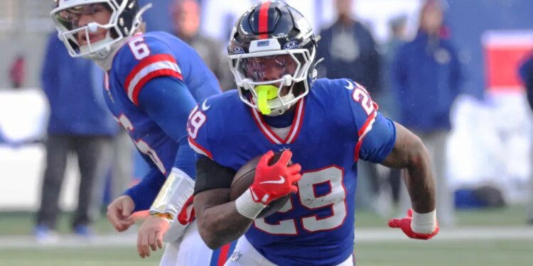 Running back Tyrone Tracy Jr. #29 of the New York Giants runs the ball during the first half.