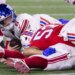 Jaxson Dart is sacked by sacked by linebacker Elijah Ponder (91) during the Giants' Week 13 loss to the Patriots.