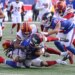 Quarterback Jaxson Dart of the New York Giants is tackled by safety Will Harris of the Washington Commanders.