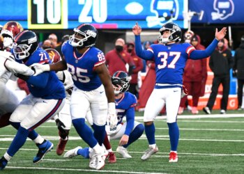 New York Giants place kicker Younghoe Koo #37 raising his arms after kicking a field goal.