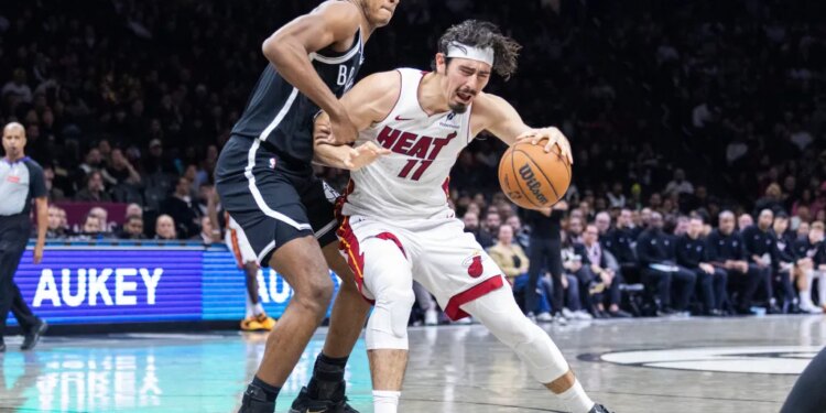 Noah Clowney #21 of the Brooklyn Nets defends against Jaime Jaquez Jr. #11 of the Miami Heat during the second half at Barclays Center, Thursday, Dec. 18, 2025, in Brooklyn, NY.