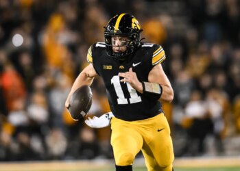 Iowa Hawkeyes quarterback Mark Gronowski (11) scrambles for yards.
