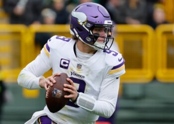 Minnesota Vikings quarterback J.J. McCarthy (9) looks to pass.