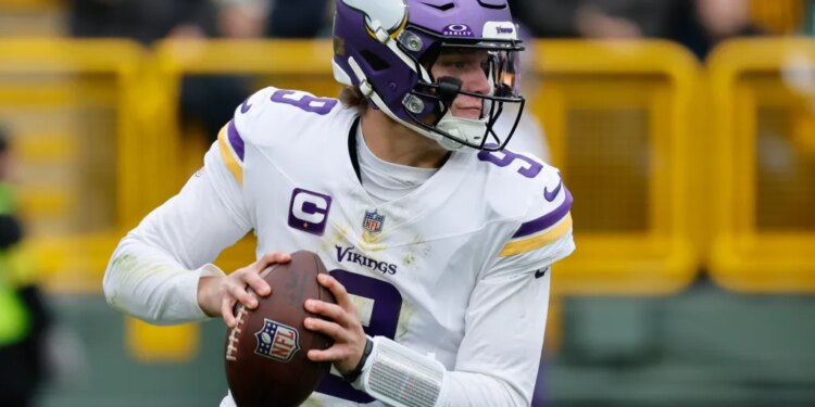 Minnesota Vikings quarterback J.J. McCarthy (9) looks to pass.