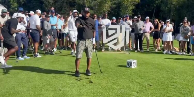 Ja Rule looking toward photographers after shanking a golf tee shot.