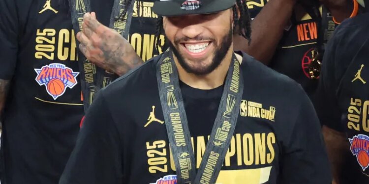 Jalen Brunson #11 of the New York Knicks is all smiles after he is presented with the NBA Cup MVP trophy after winning the NBA Cup.