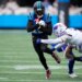 Carolina Panthers quarterback Hendon Hooker (12) runs against Buffalo Bills cornerback Taron Johnson (7).
