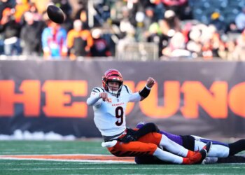 Cincinnati Bengals quarterback Joe Burrow (9) throws as he is tackled by Baltimore Ravens linebacker Kyle van Noy during the second half of an NFL football game, Sunday, Dec. 14, 2025, in Cincinnati.