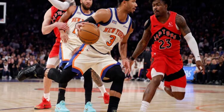 New York Knicks guard Josh Hart drives to the basket as Toronto Raptors guard Jamal Shead gives chase.