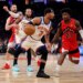 New York Knicks guard Josh Hart drives to the basket as Toronto Raptors guard Jamal Shead gives chase.