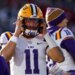LSU quarterback Michael van Buren Jr. (11) puts on his helmet before a play against Oklahoma during the first half of an NCAA college football game Saturday, Nov. 29, 2025, in Norman, Okla.