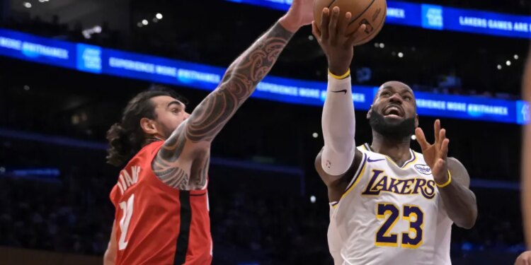 Rockets center Steven Adams, left, blocks a shot by Lakers forward LeBron James during the second half on Dec. 25, 2025.
