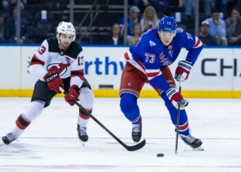 New Jersey Devils center Nico Hischier (13) pursues New York Rangers center Matt Rempe (73) in the first period at Madison Square Garden, Thursday, Oct. 2, 2025, in New York, NY.
