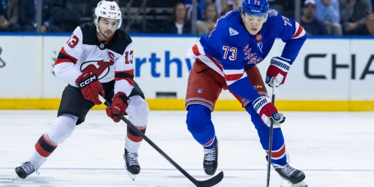 New Jersey Devils center Nico Hischier (13) pursues New York Rangers center Matt Rempe (73) in the first period at Madison Square Garden, Thursday, Oct. 2, 2025, in New York, NY.