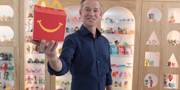 McDonald's CEO Chris Kempczinski holding a Happy Meal box.