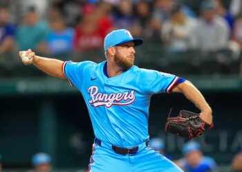 Texas Rangers starting pitcher Merrill Kelly throws a pitch during the first inning of a baseball game against the Miami Marlins on Sunday, Sept. 21, 2025, in Arlington, Texas.