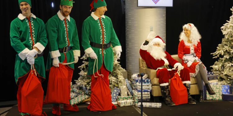 Left to right: Jonah Tong, Nolan McLean, Brandon Sproat dress as elves and Clay Holmes as Santa with his wife, Ashlyn as Mrs. Claus, prepare to give gifts away to the children during the Mets Annual Kids Holiday Party on Dec. 18, 2025 at Citi Field.