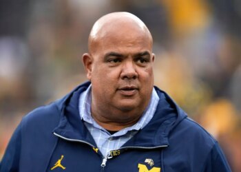 Warde Manuel watches in the second half of an NCAA college football game against UNLV in Ann Arbor, Mich., Sept. 9, 2023.