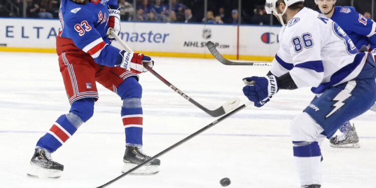 New York Rangers center Mika Zibanejad (93) takes a shot as Tampa Bay Lightning right wing Nikita Kucherov (86) defends.