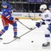 New York Rangers center Mika Zibanejad (93) takes a shot as Tampa Bay Lightning right wing Nikita Kucherov (86) defends.