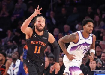 New York Knicks guard Jalen Brunson #11 reacts after hitting a three-point shot during the third quarter.
