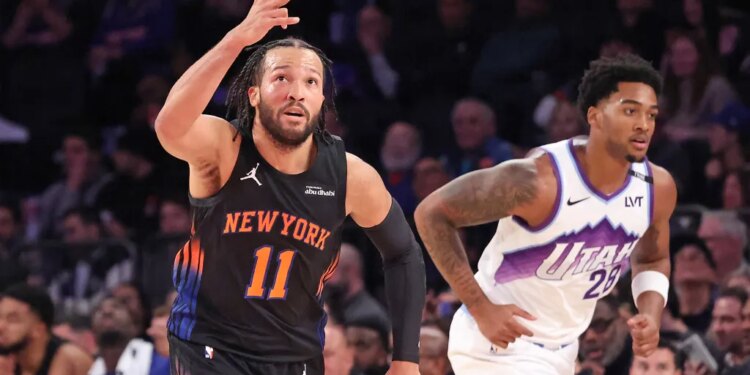 New York Knicks guard Jalen Brunson #11 reacts after hitting a three-point shot during the third quarter.