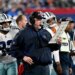 Dallas Cowboys head coach Mike McCarthy on the sideline holding a play chart.